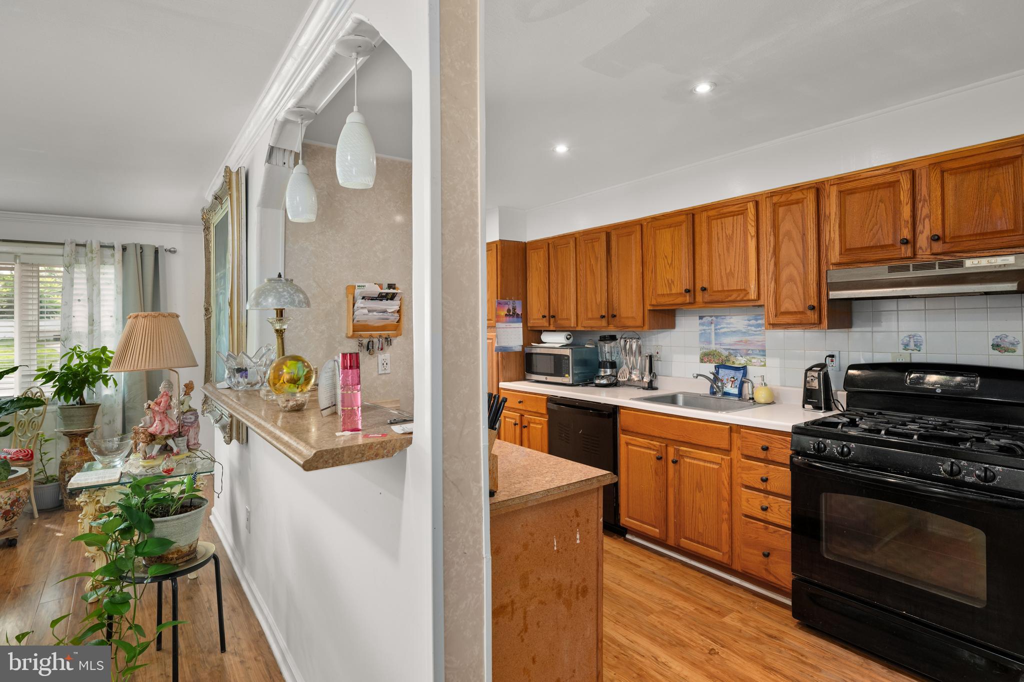 7 Gainor Road New Castle, DE 19720 - Photo 6 of 26 a kitchen with stainless steel appliances granite countertop a stove a sink dishwasher and a refrigerator with wooden floor