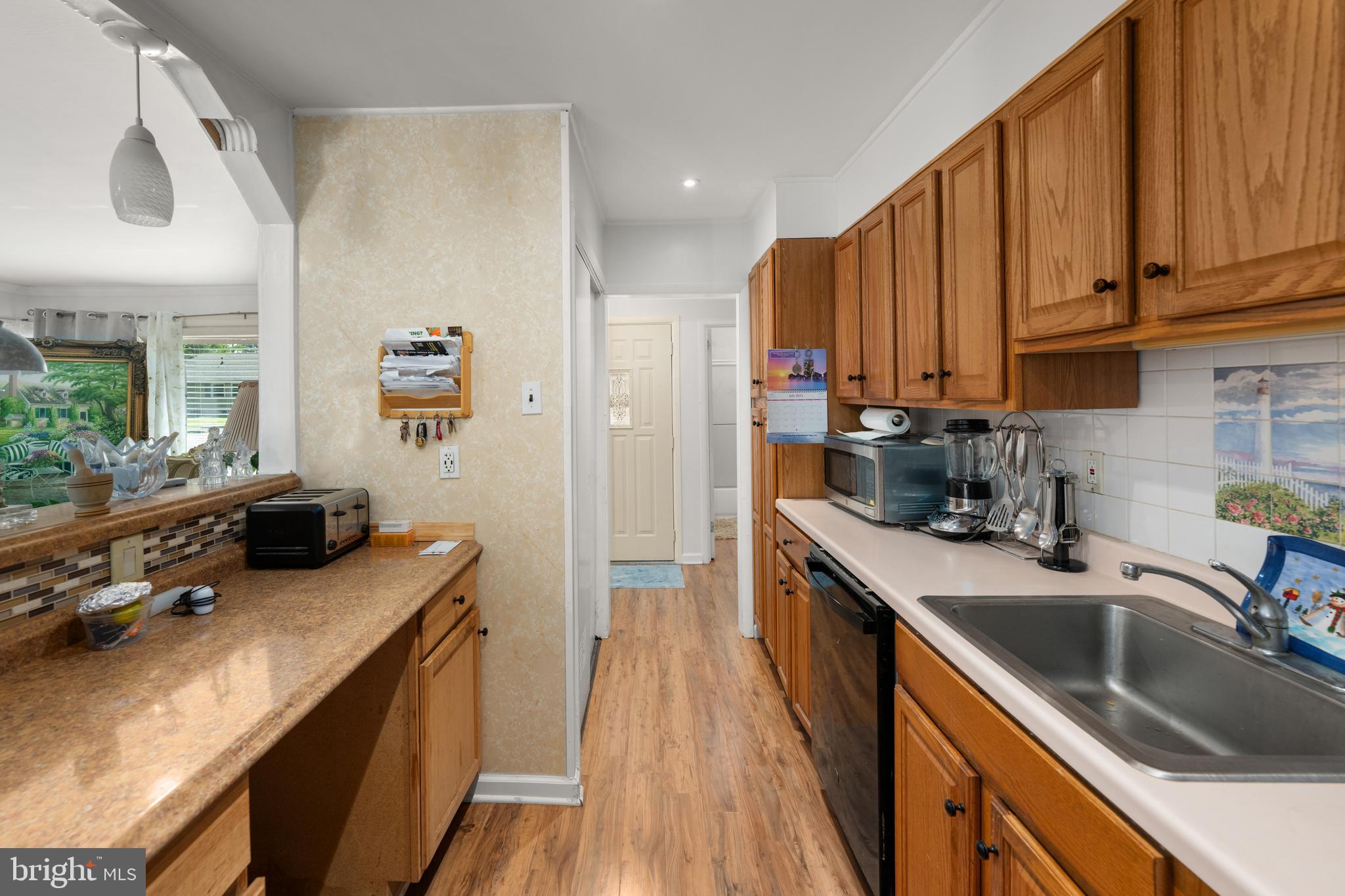 7 Gainor Road New Castle, DE 19720 - Photo 7 of 26 a kitchen with stainless steel appliances a sink stove and cabinets