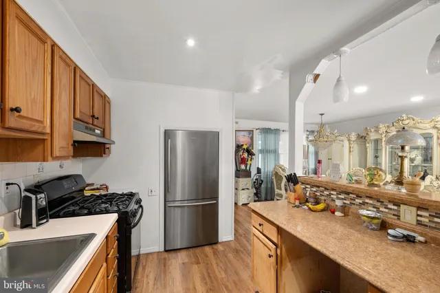 a kitchen with refrigerator and stove
