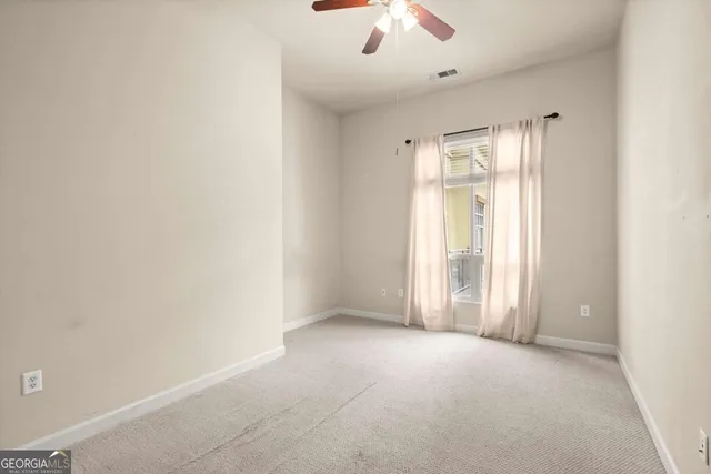 an empty room with a empty space and a ceiling fan