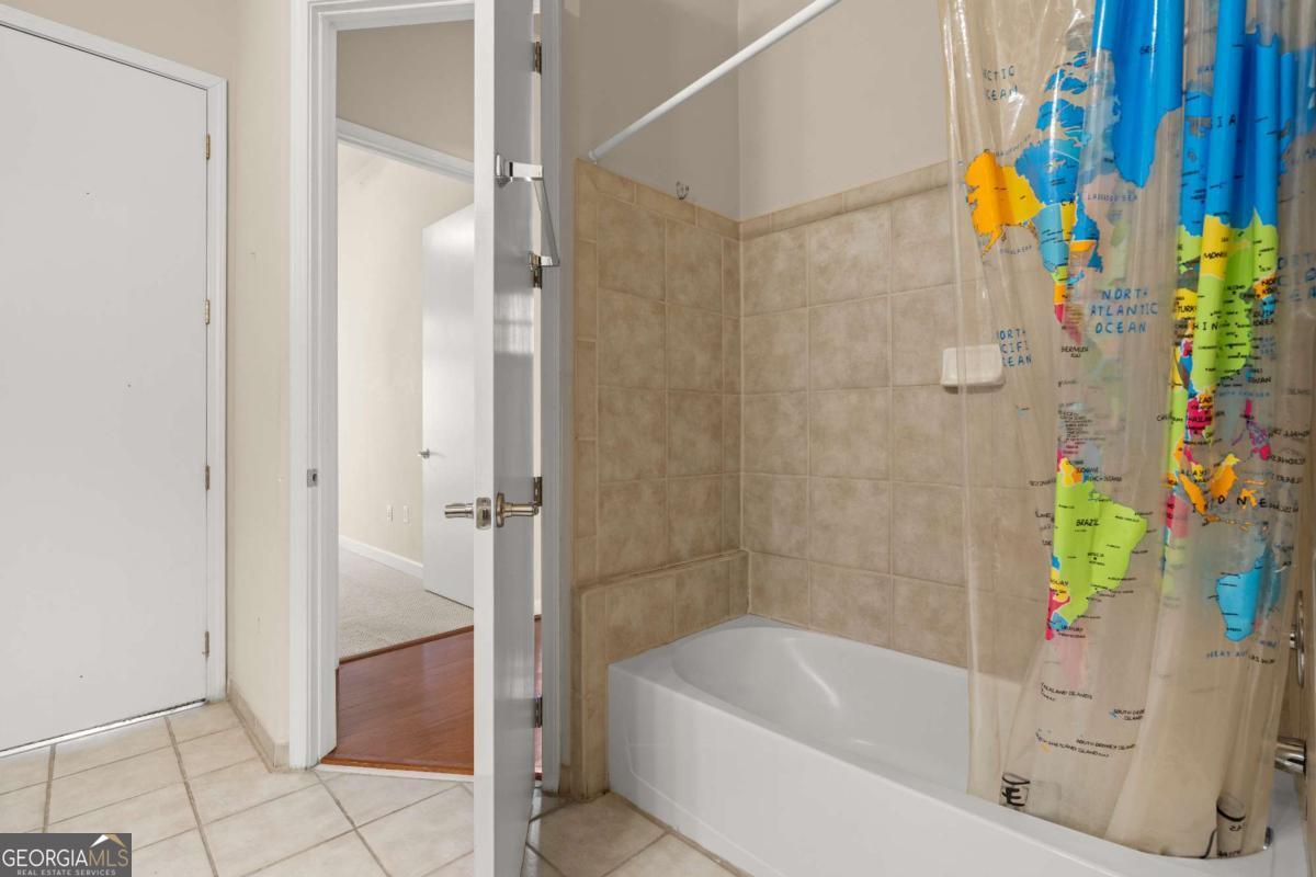 711 Cosmopolitan Drive Northeast, Unit 442 Atlanta, GA 30324 - Photo 20 of 32 a bathroom with a tub and shower