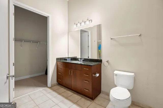 a bathroom with a toilet a sink and a mirror