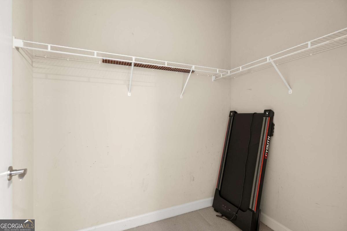 711 Cosmopolitan Drive Northeast, Unit 442 Atlanta, GA 30324 - Photo 22 of 32 a view of walk in closet with clothes