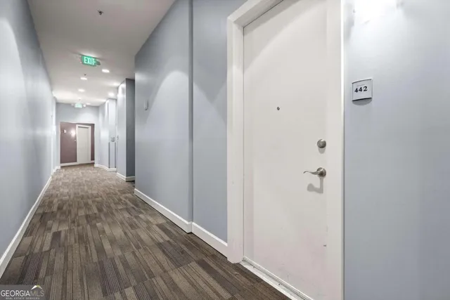 a view of hallway with wooden floor