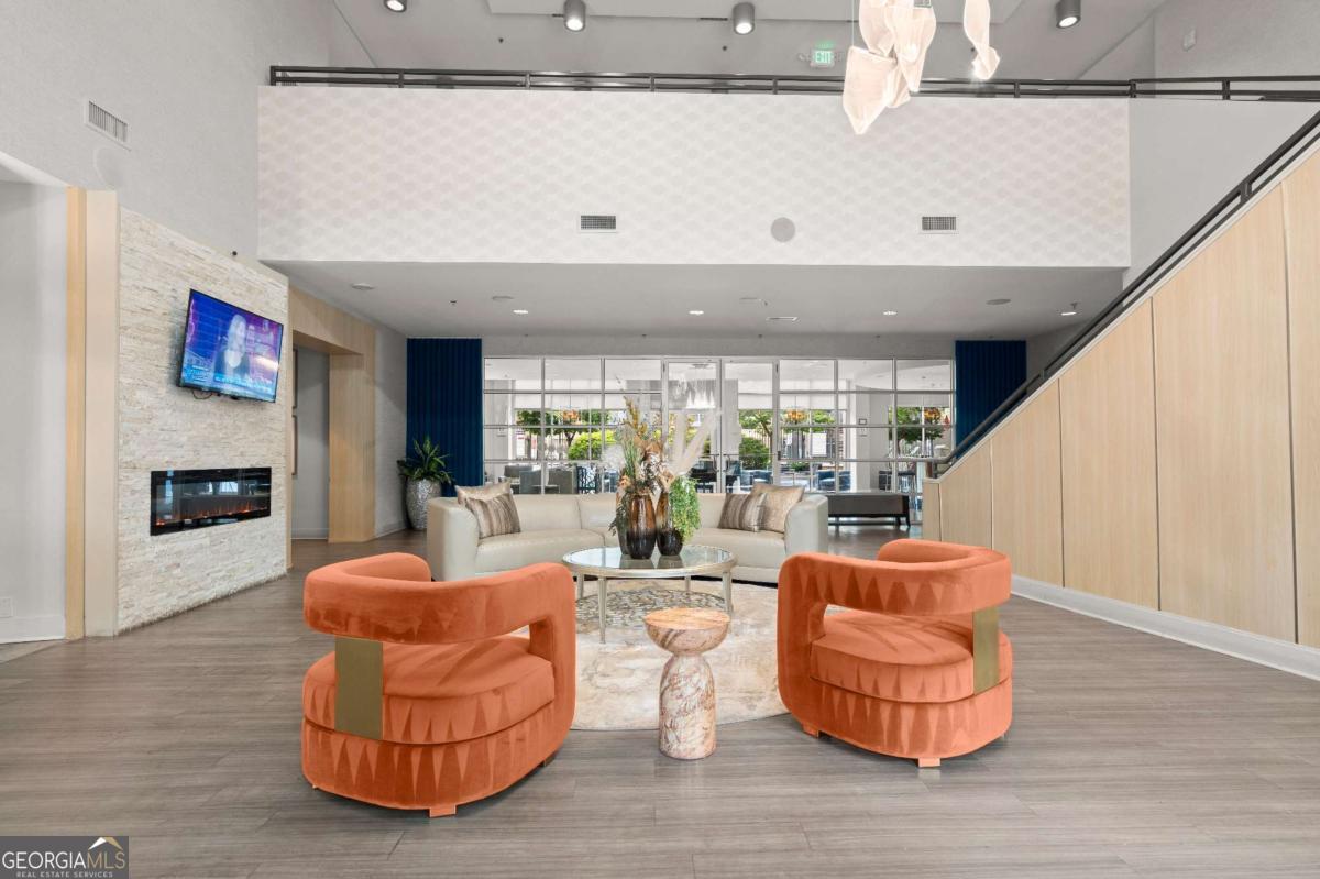 711 Cosmopolitan Drive Northeast, Unit 442 Atlanta, GA 30324 - Photo 31 of 32 a living room with fireplace furniture and a wooden floor