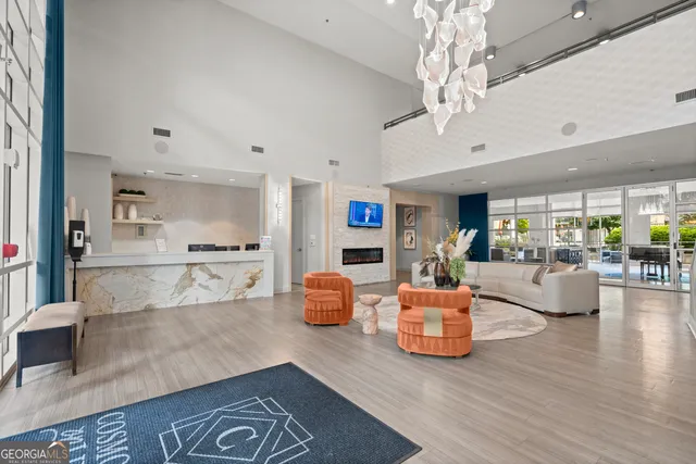 a living room with furniture and a chandelier