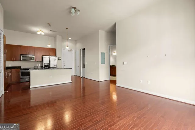 a view of kitchen with cabinets and wooden floor