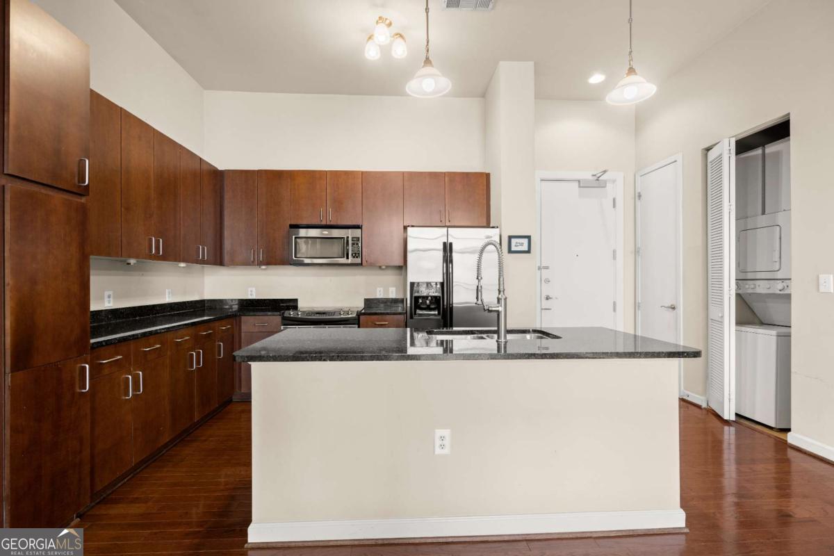 711 Cosmopolitan Drive Northeast, Unit 442 Atlanta, GA 30324 - Photo 8 of 32 a kitchen with stainless steel appliances granite countertop a sink a stove and a refrigerator