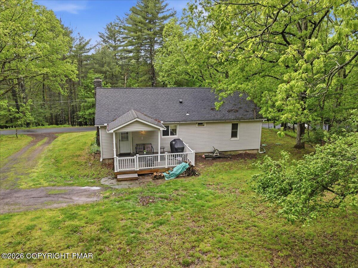 232 Garrity Road Hawley, PA 18428 - Photo 48 of 57 a aerial view of a house with table and chairs under an umbrella