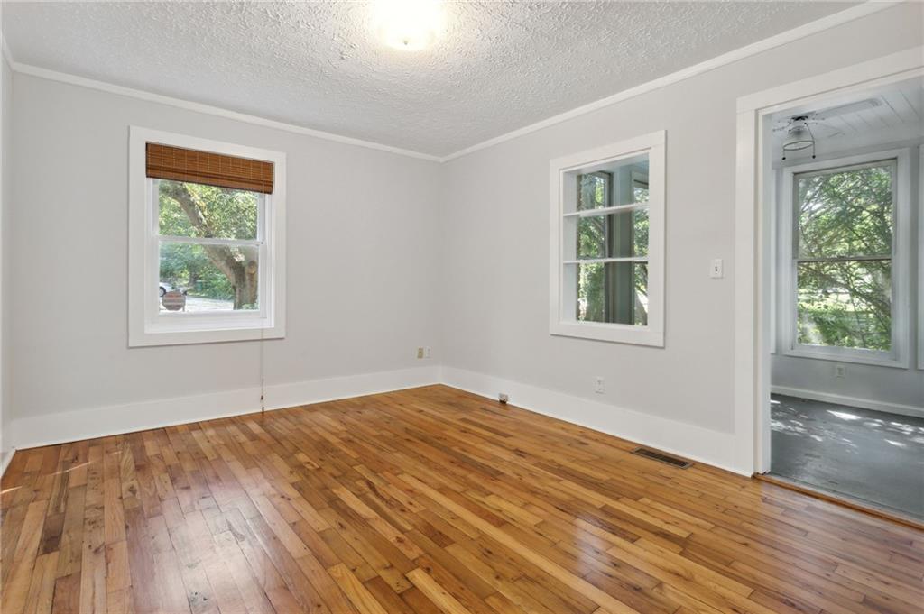 385 Sunset Drive Athens, GA 30606 - Photo 22 of 48 a view of empty room with wooden floor and fan