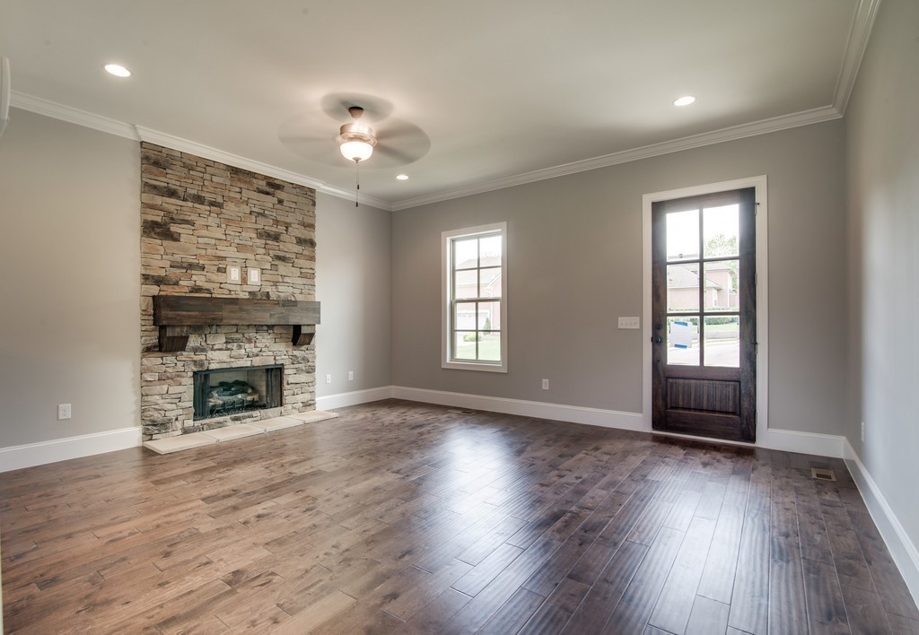19 Bear Branch Place Joelton, TN 37080 - Photo 3 of 16 an empty room with wooden floor fireplace and windows