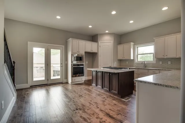 a large kitchen with lots of counter space and stainless steel appliances