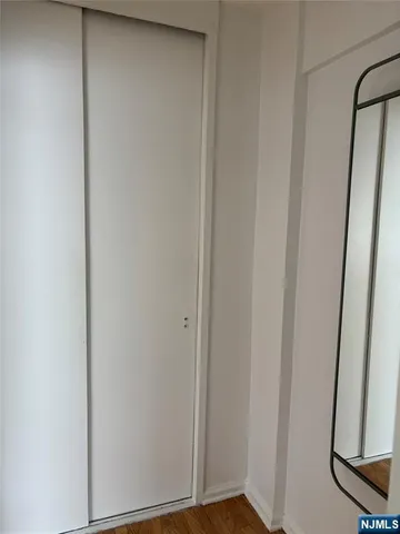 a view of a small space with wooden floor and a window