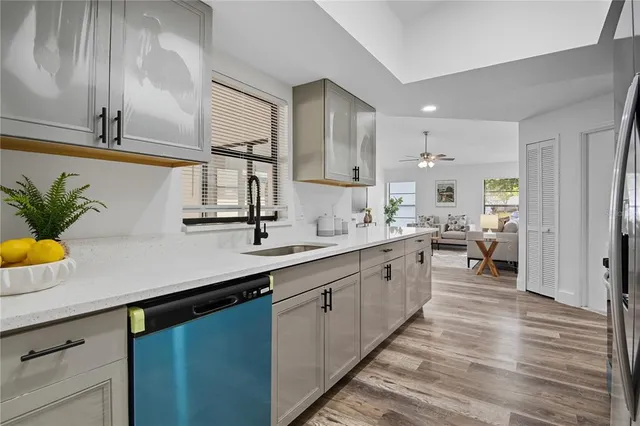 a large kitchen with stainless steel appliances lots of counter space and a sink