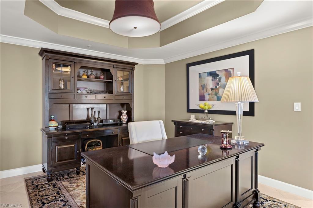 8990 Bay Colony Drive, Unit 1002 Naples, FL 34108 - Photo 11 of 20 a living room with furniture and window