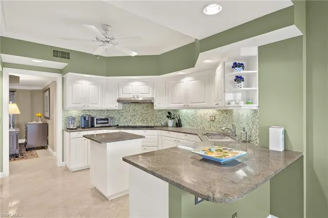 a kitchen with a sink a stove and chairs