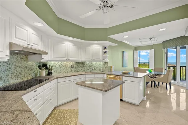 a kitchen with granite countertop a sink a counter top space and stainless steel appliances