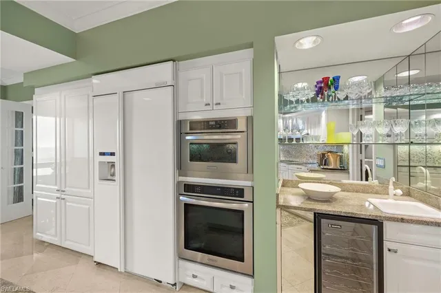 a kitchen with cabinets and stainless steel appliances