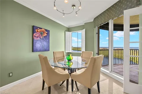 a view of a dining room with furniture a chandelier and wooden floor