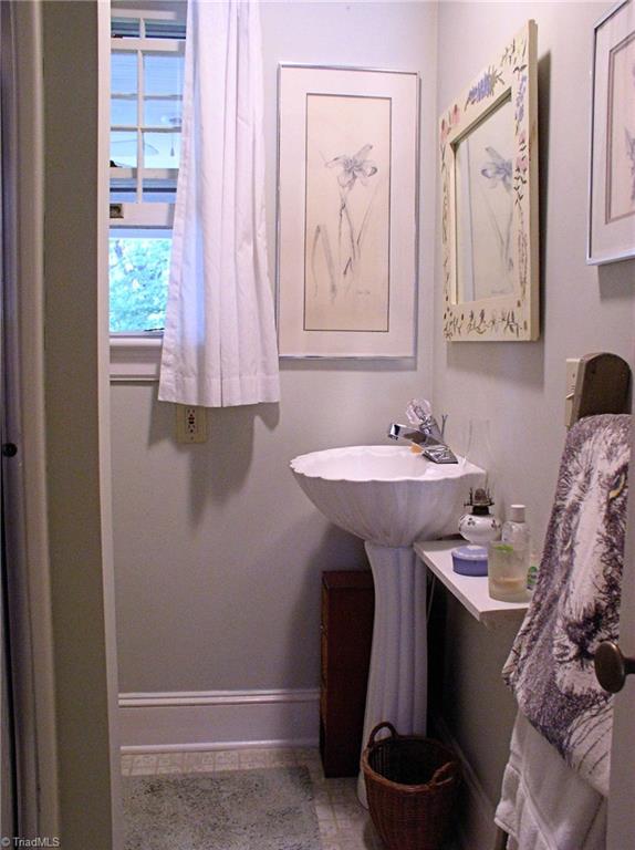 383 Hawthorne Road Elkin, NC 28621 - Photo 13 of 30 Full bath on main level features pedestal sink and walk-in shower.