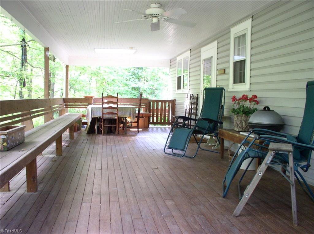 383 Hawthorne Road Elkin, NC 28621 - Photo 22 of 30 Expansive covered deck with built-in bench seating spans the width of the home.