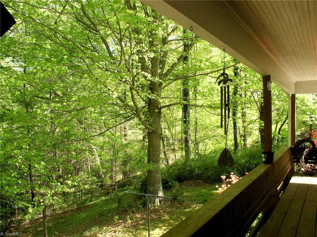 383 Hawthorne Road Elkin, NC 28621 - Photo 23 of 30 Enjoy wooded views from the covered back deck.