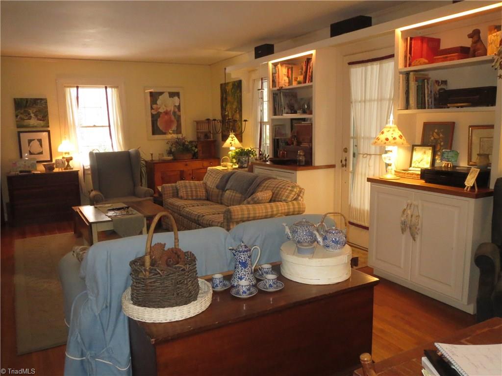 383 Hawthorne Road Elkin, NC 28621 - Photo 6 of 30 Living room also features built-in shelving and cabinetry as well as doorway to screened side porch.