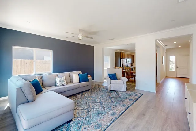 a living room with furniture and wooden floor