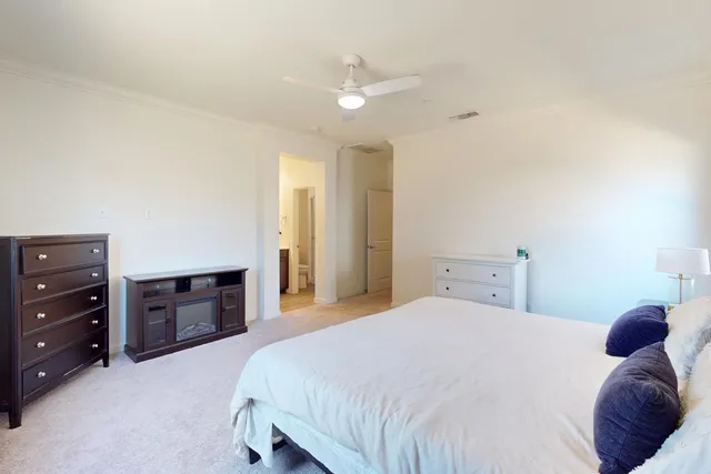 a bedroom with a bed and a dresser