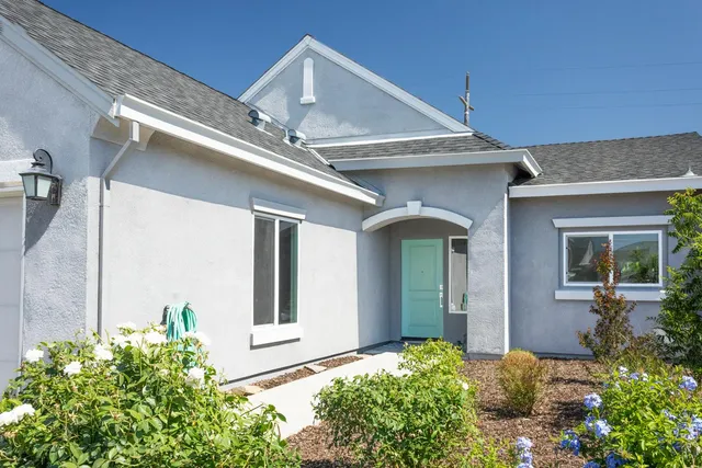 a front view of a house with garden
