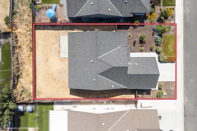 an aerial view of a house with pool and yard