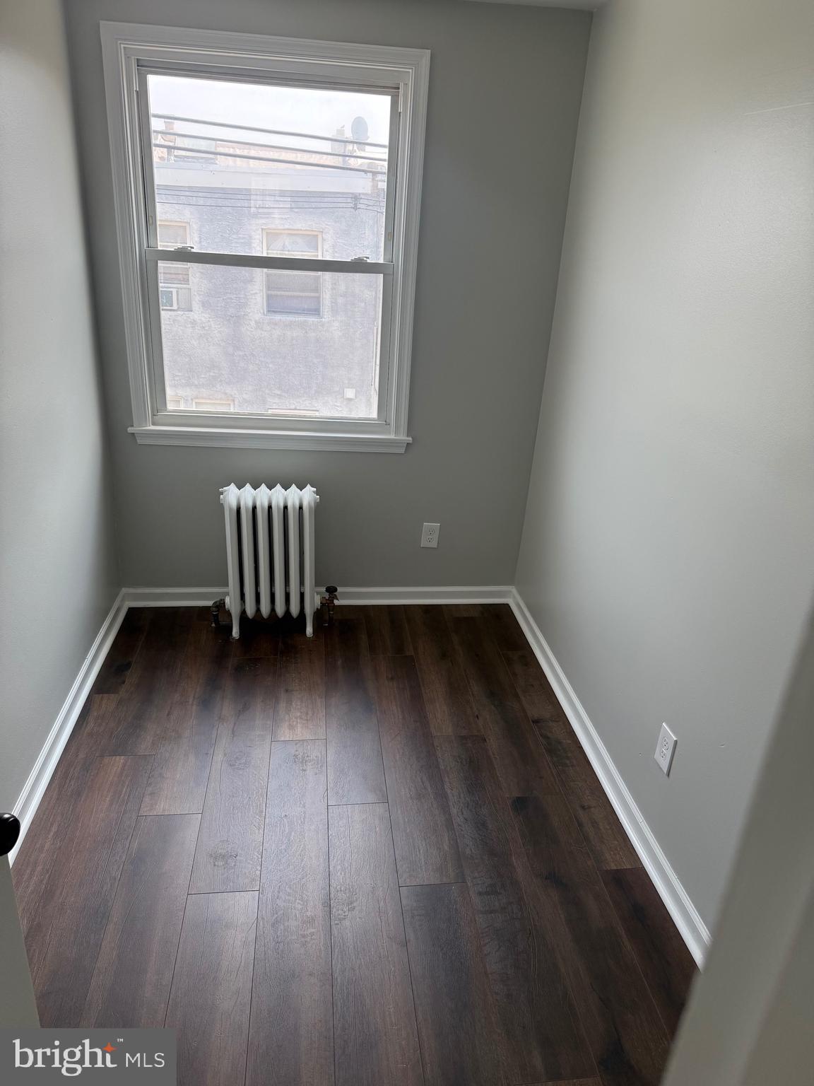 7150 Radbourne Road Upper Darby, PA 19082 - Photo 11 of 16 an empty room with wooden floor and windows