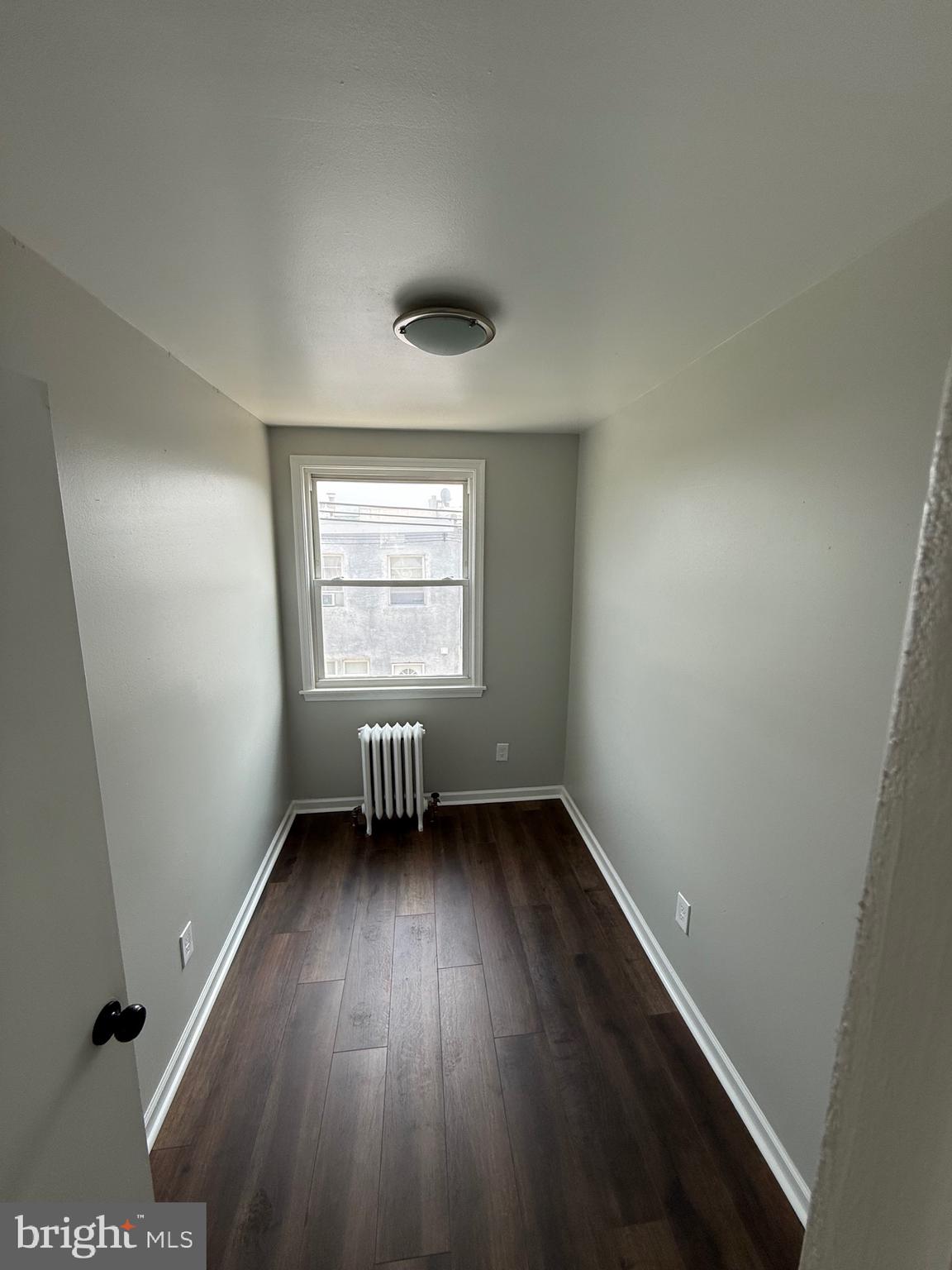 7150 Radbourne Road Upper Darby, PA 19082 - Photo 12 of 16 an empty room with wooden floor and windows