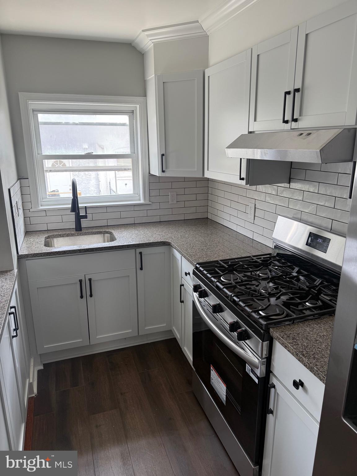 7150 Radbourne Road Upper Darby, PA 19082 - Photo 5 of 16 a kitchen with granite countertop a stove and a sink