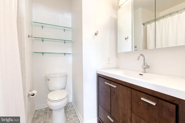 a bathroom with a toilet sink and mirror