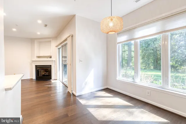 a view of a livingroom with a ceiling fan window and wooden floor