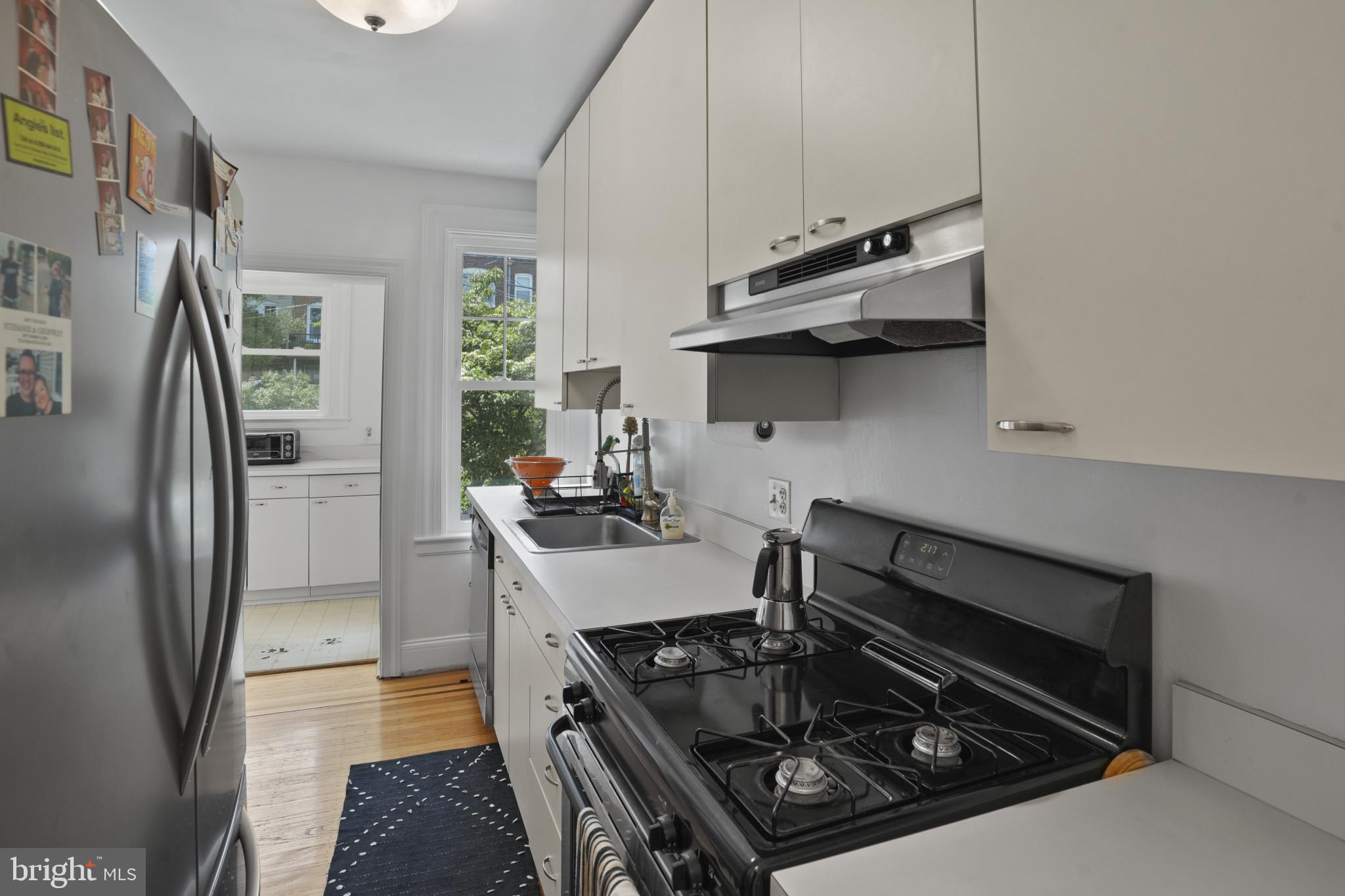 3618 Ednor Road Baltimore, MD 21218 - Photo 12 of 30 a kitchen with stainless steel appliances granite countertop a stove and a refrigerator