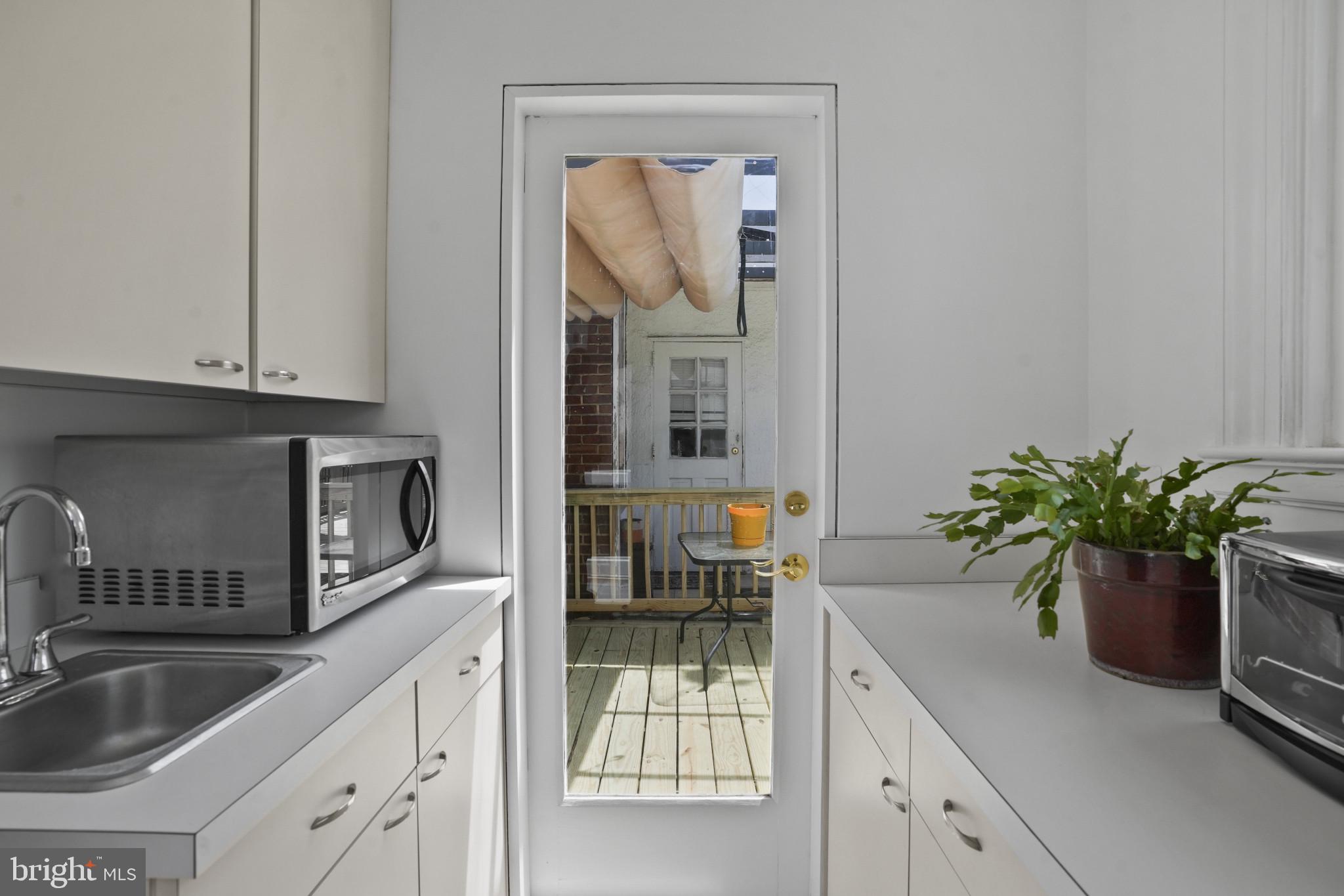 3618 Ednor Road Baltimore, MD 21218 - Photo 14 of 30 a kitchen with a refrigerator a sink and potted plant