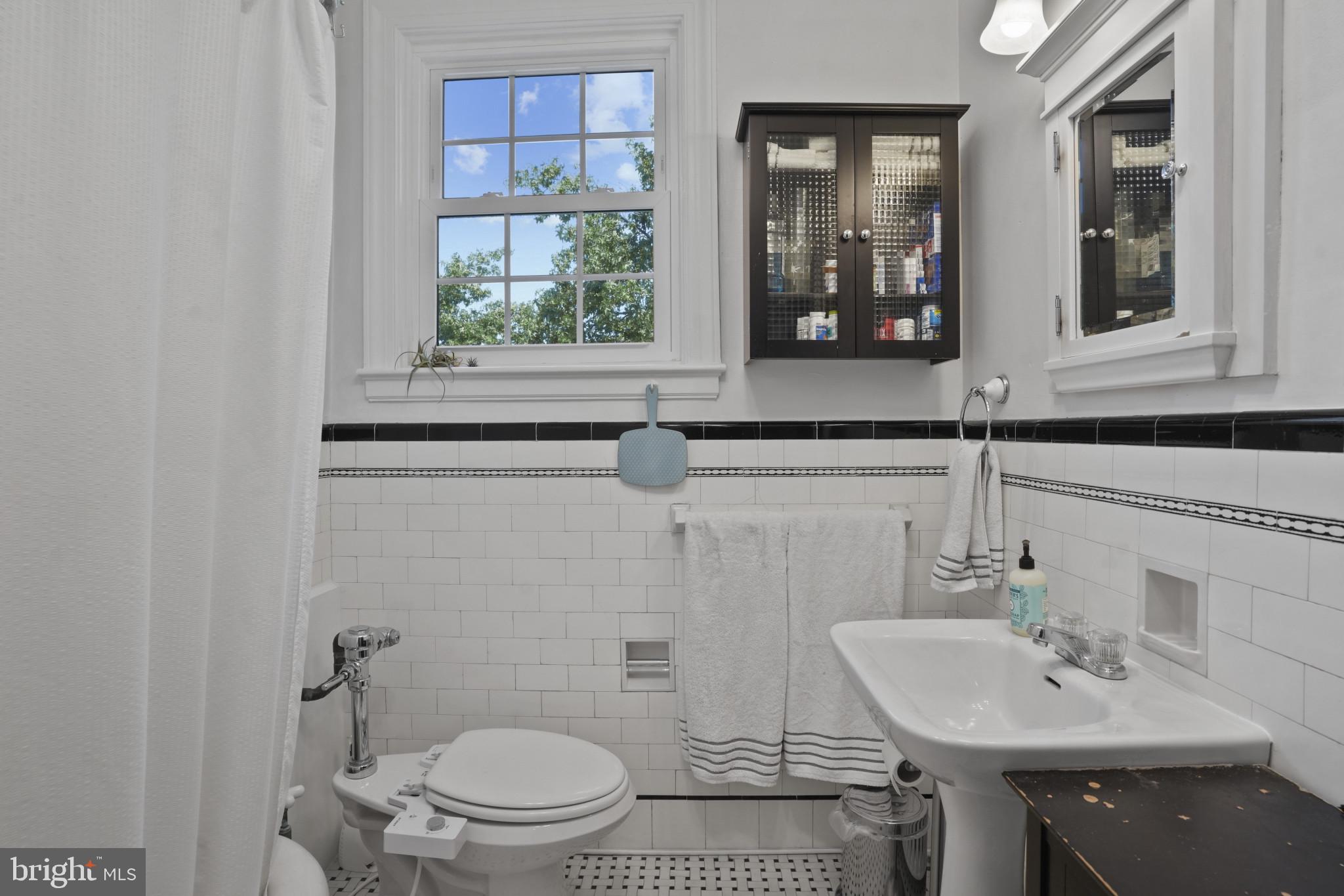 3618 Ednor Road Baltimore, MD 21218 - Photo 20 of 30 a bathroom with a sink a toilet and mirror