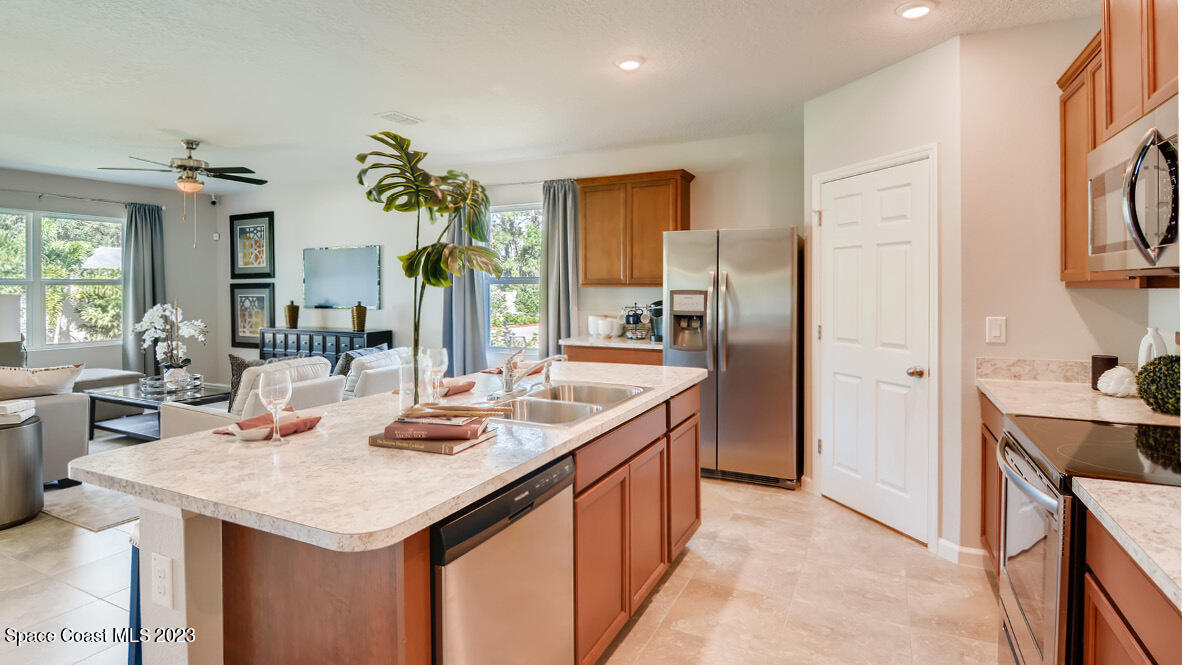 409 Old Road Palm Bay, FL 32908 - Photo 2 of 15 a kitchen with a sink refrigerator and cabinets