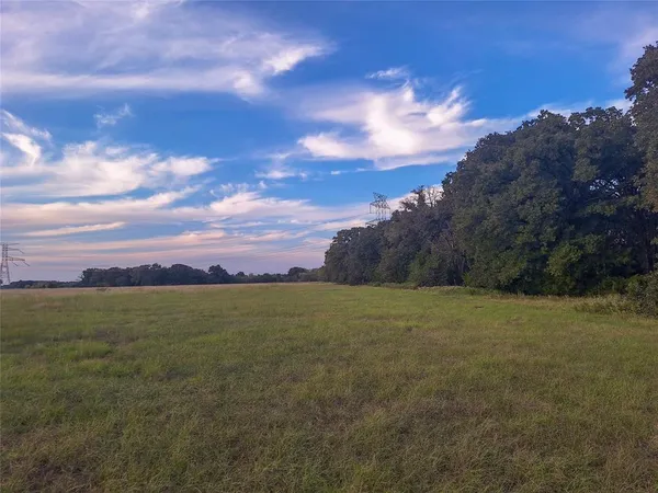 a view of a field with an ocean and mountain view