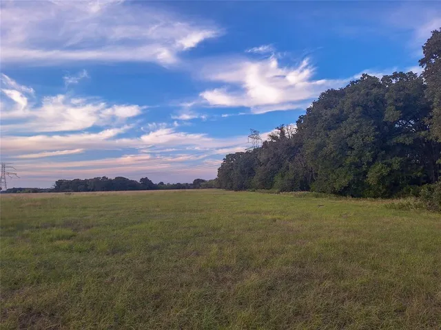 a view of a field with an ocean and mountain view