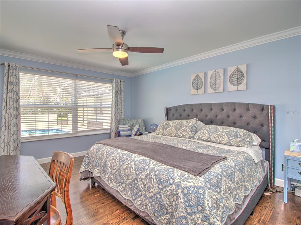 2313 Southeast 7th Street Ocala, FL 34471 - Photo 14 of 42 a bedroom with a bed and wooden floor