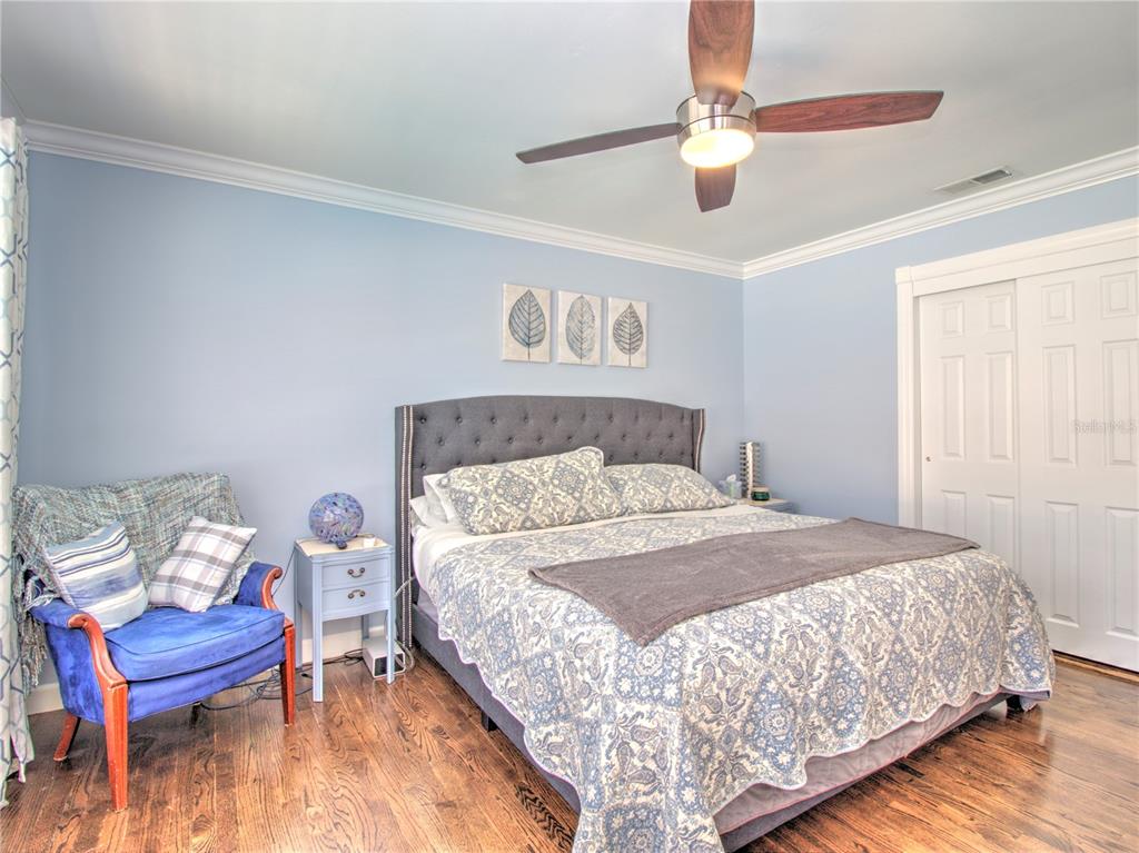 2313 Southeast 7th Street Ocala, FL 34471 - Photo 15 of 42 a bedroom with a bed and a chandelier