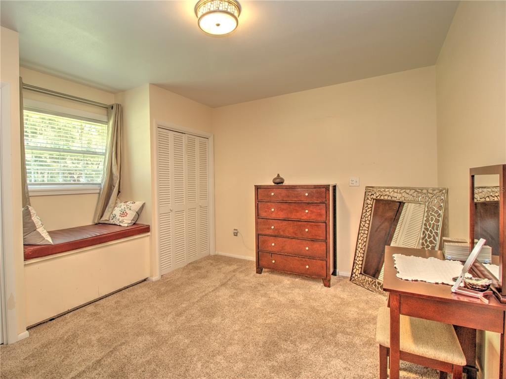 2313 Southeast 7th Street Ocala, FL 34471 - Photo 22 of 42 a view of a bedroom with furniture and a window
