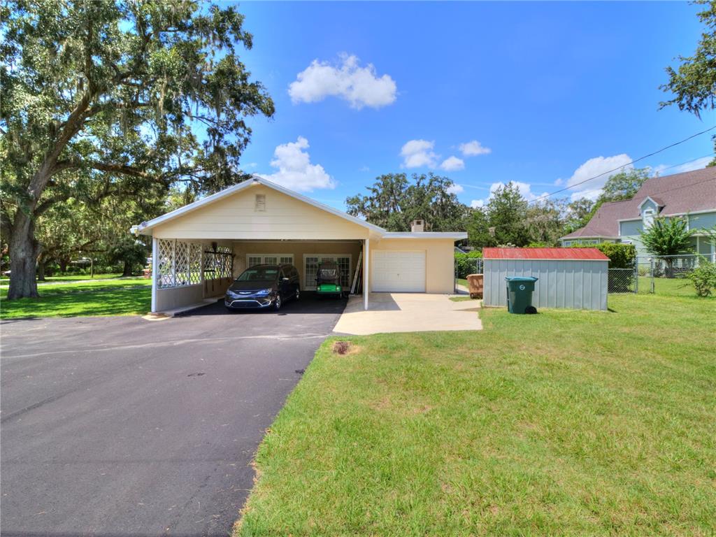 2313 Southeast 7th Street Ocala, FL 34471 - Photo 37 of 42 a front view of a house with a garden and tree