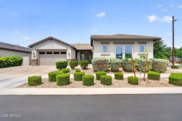 a front view of house with yard and outdoor seating