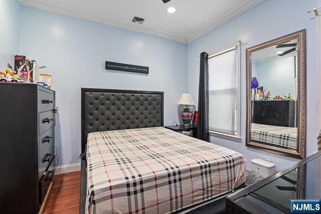 7 Martin Street Paterson, NJ 07501 - Photo 11 of 18 a bedroom with a bed and a dresser