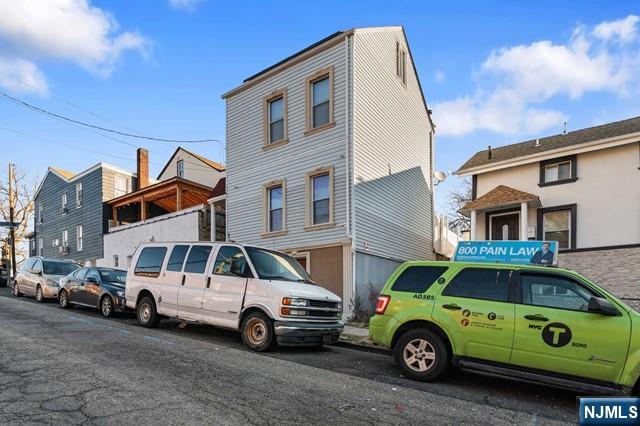 7 Martin Street Paterson, NJ 07501 - Photo 16 of 18 a car parked in front of a house