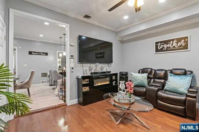 7 Martin Street Paterson, NJ 07501 - Photo 2 of 18 a living room with furniture and a flat screen tv